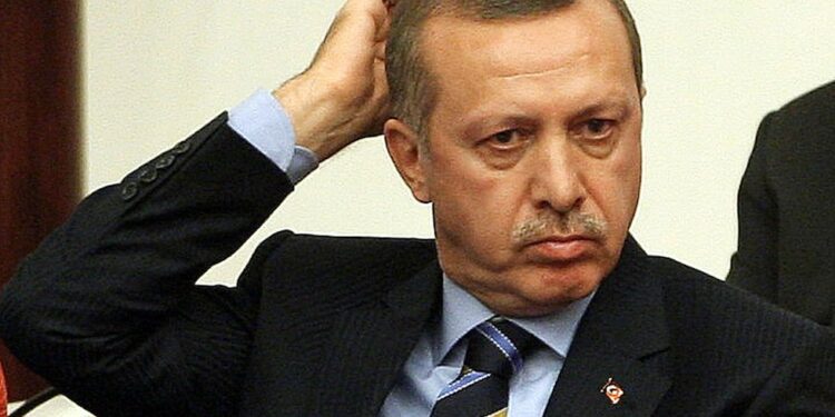 Turkey's Prime Minister Recep Tayyip Erdogan gestures as he listens to Interior Minister Besir Atalay (not pictured) addressing MPs during a debate at the Turkish Parliament, on November 13, 2009 in Ankara. Turkey's parliament is set to discuss on reforms designed to boost the rights of the country's Kurdish minority and end a 25-year separatist conflict, moves seen boosting its European Union membership ambitions.     AFP PHOTO/ ADEM ALTAN