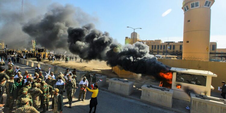 31 December 2019, Iraq, Baghdad: Iraqi Shiite militia supporters burn property during a demonstration inside the US embassy compound in Baghdad. Iraqi mourners on Tuesday stormed the building of the US embassy in Baghdad's heavily fortified Green Zone after deadly US airstrikes on sites of a Shiite militia. Photo: Ameer Al Mohmmedaw/dpa (Photo by Ameer Al Mohmmedaw/picture alliance via Getty Images)