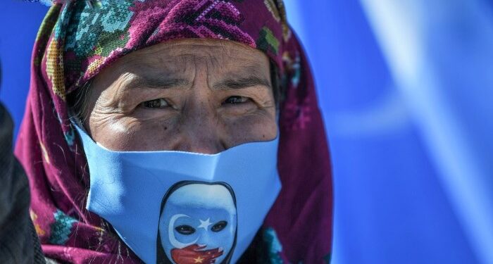 A supporter of China's Muslim Uighur minority wears a face mask with the flag of East Turkestan during a demonstration by supporters of China's Muslim Uighur minority against China's Uighur treatment at the Beyazid square on October 1, 2020 in Istanbul. (Photo by Ozan KOSE / AFP)