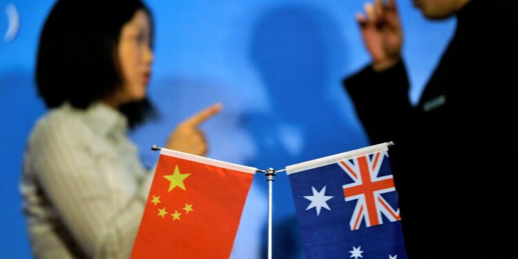 FILE PHOTO: Staff members chat as they prepare a seminar of Australia China bilateral cooperation in resources and infrastructure in West Australia, in Beijing July 23, 2009. REUTERS/Jason Lee