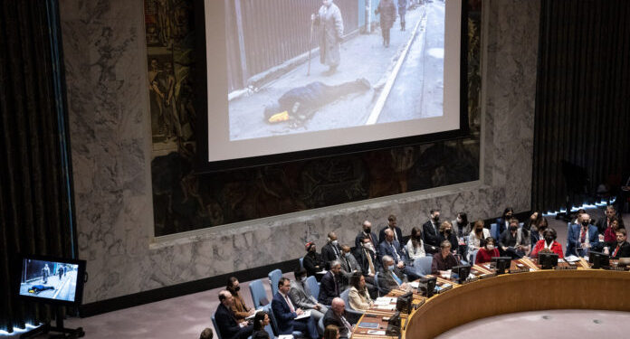 Images from devastation in Ukraine are displayed during a meeting of the UN Security Council, Tuesday, April 5, 2022, at United Nations headquarters. Ukrainian President Volodymyr Zelenskyy addressed the U.N. Security Council for the first time Tuesday at a meeting focused on what appears to be widespread deliberate killings of civilians by Russian troops. Videos of streets in the town of Bucha outside Kyiv strewn with corpses have sparked global outrage and vehement denials from the Russian government that it was responsible. (AP Photo/John Minchillo)