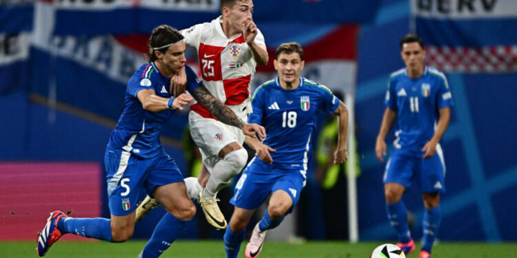 (From L) Italy's defender #05 Riccardo Calafiori, Croatia's midfielder #25 Luka Susic and Italy's midfielder #18 Nicolo Barella fight for the ball during the UEFA Euro 2024 Group B football match between Croatia and Italy at the Leipzig Stadium in Leipzig on June 24, 2024. (Photo by GABRIEL BOUYS / AFP)