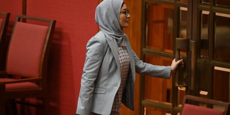 Labor Senator Fatima Payman walks out the chamber after crossing the floor on a motion moved by the Australian Greens to recognize the State of Palestine during debate in the Senate chamber at Parliament House in Canberra, Tuesday, June 25, 2024. (AAP Image/Lukas Coch) NO ARCHIVING